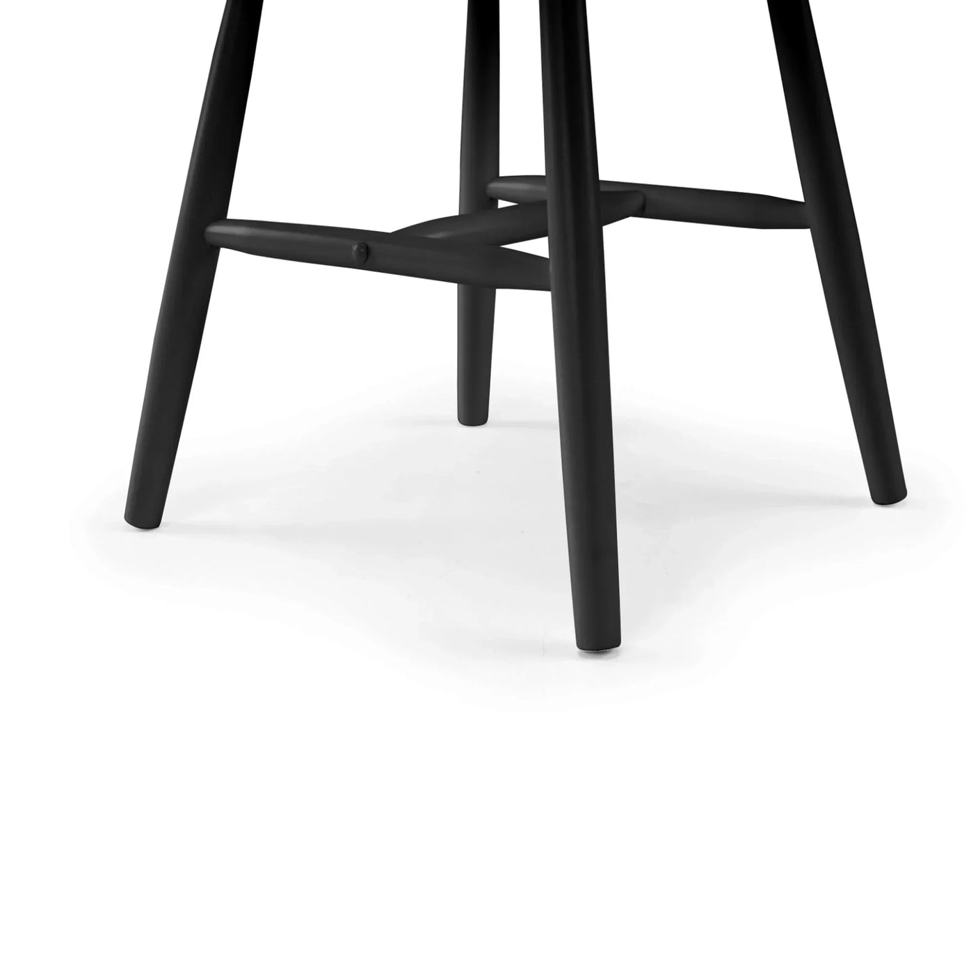 Black dining chair legs with crossbar detail on white background