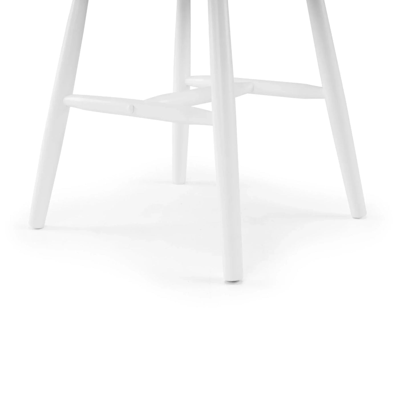 Closeup of white wooden dining chair legs and cross supports on white background