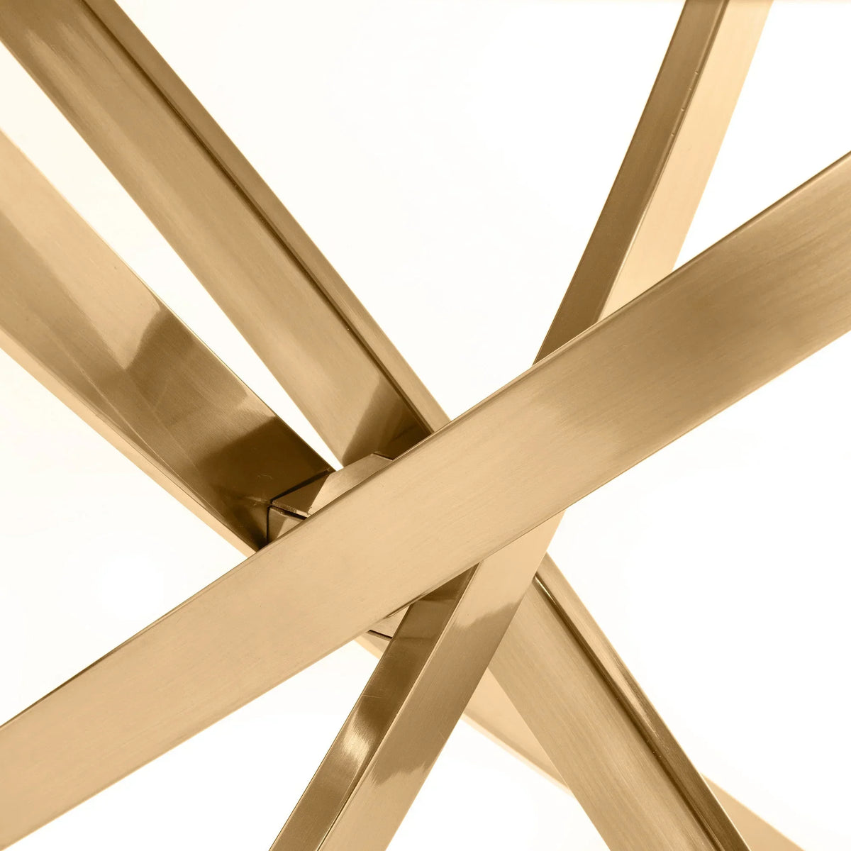 Gold metal table legs with modern intersecting design, close up on stylish furniture base