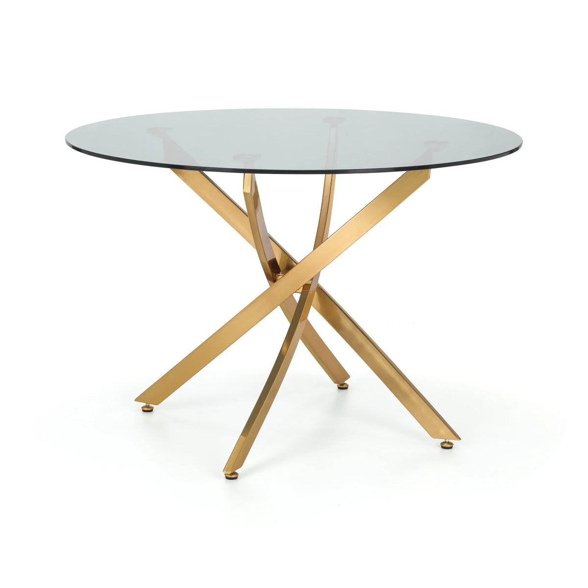 Round glass dining table with gold metal crossed legs on white background