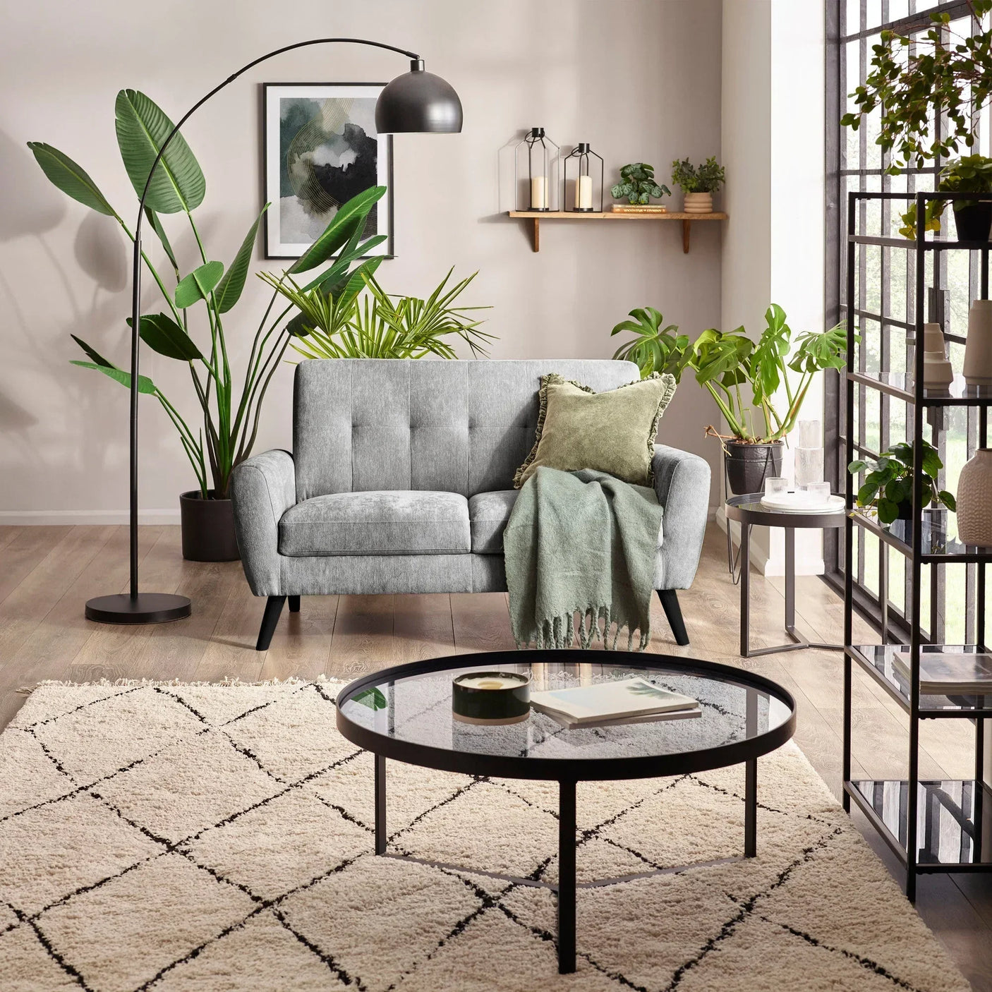 Dove grey two seater sofa with cushions and throw in modern living room setting