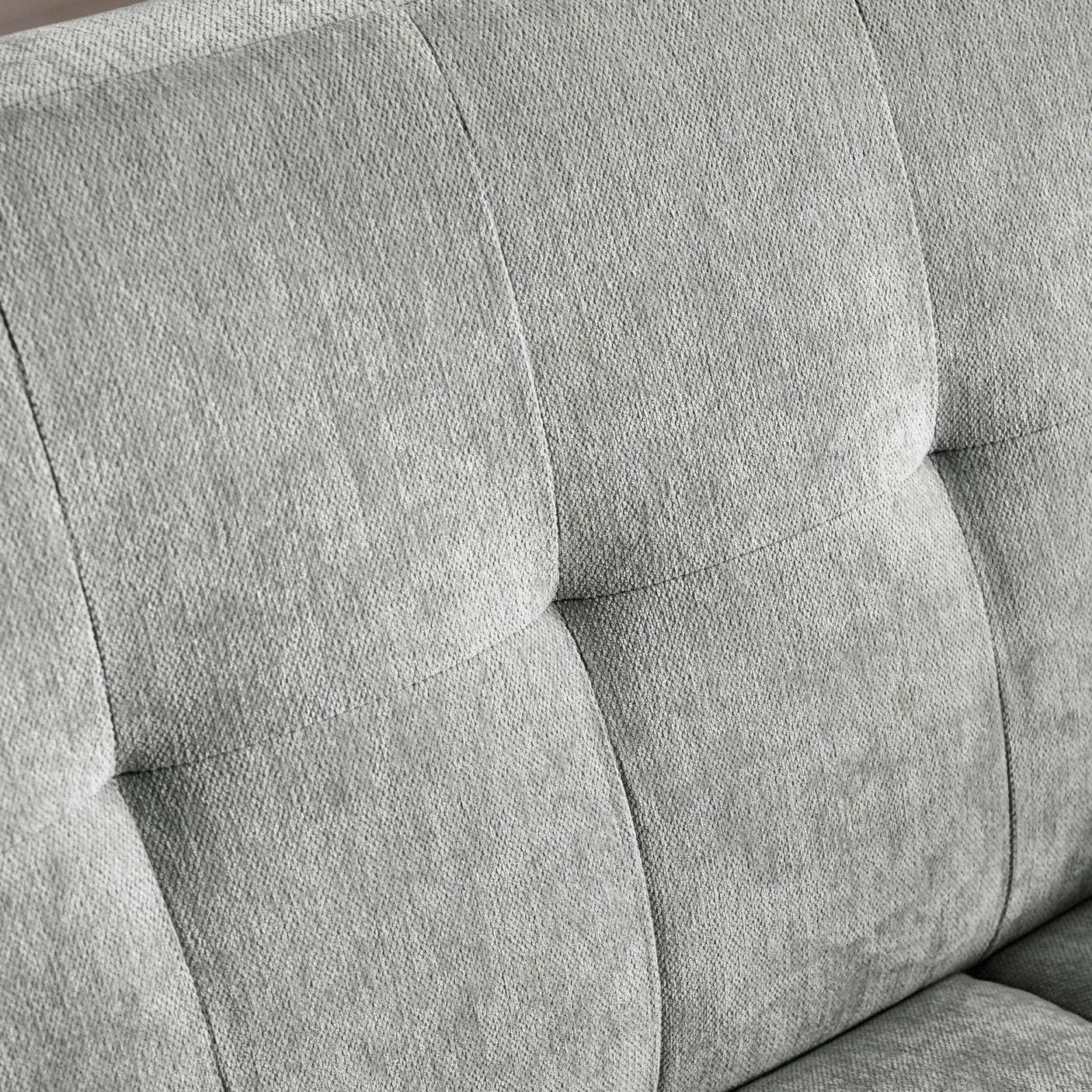 Grey fabric sofa backrest with square tufted stitching detail