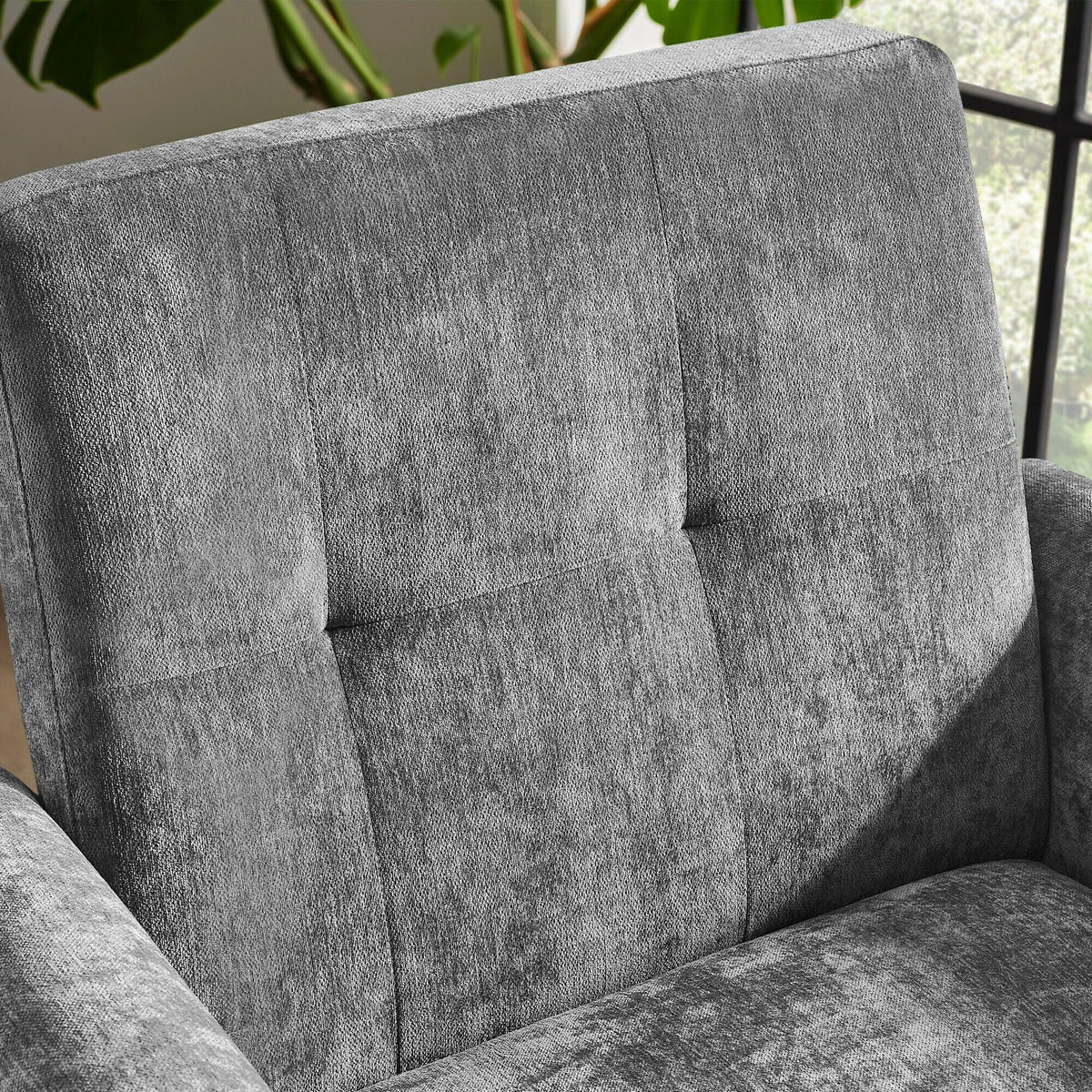 Close up of grey fabric armchair backrest with plush texture and vertical stitched panels