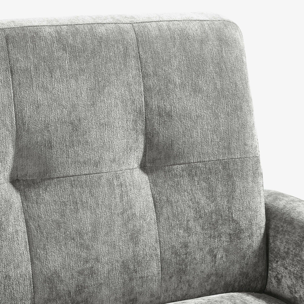 Grey fabric sofa backrest with stitched square pattern and padded armrest close-up