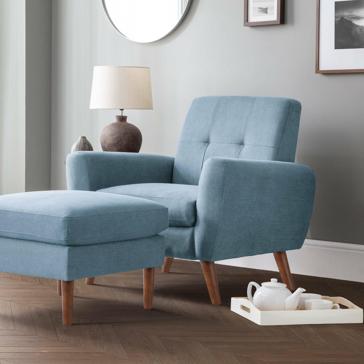Monza blue chair with matching footstool, wooden legs, placed in modern living room setting