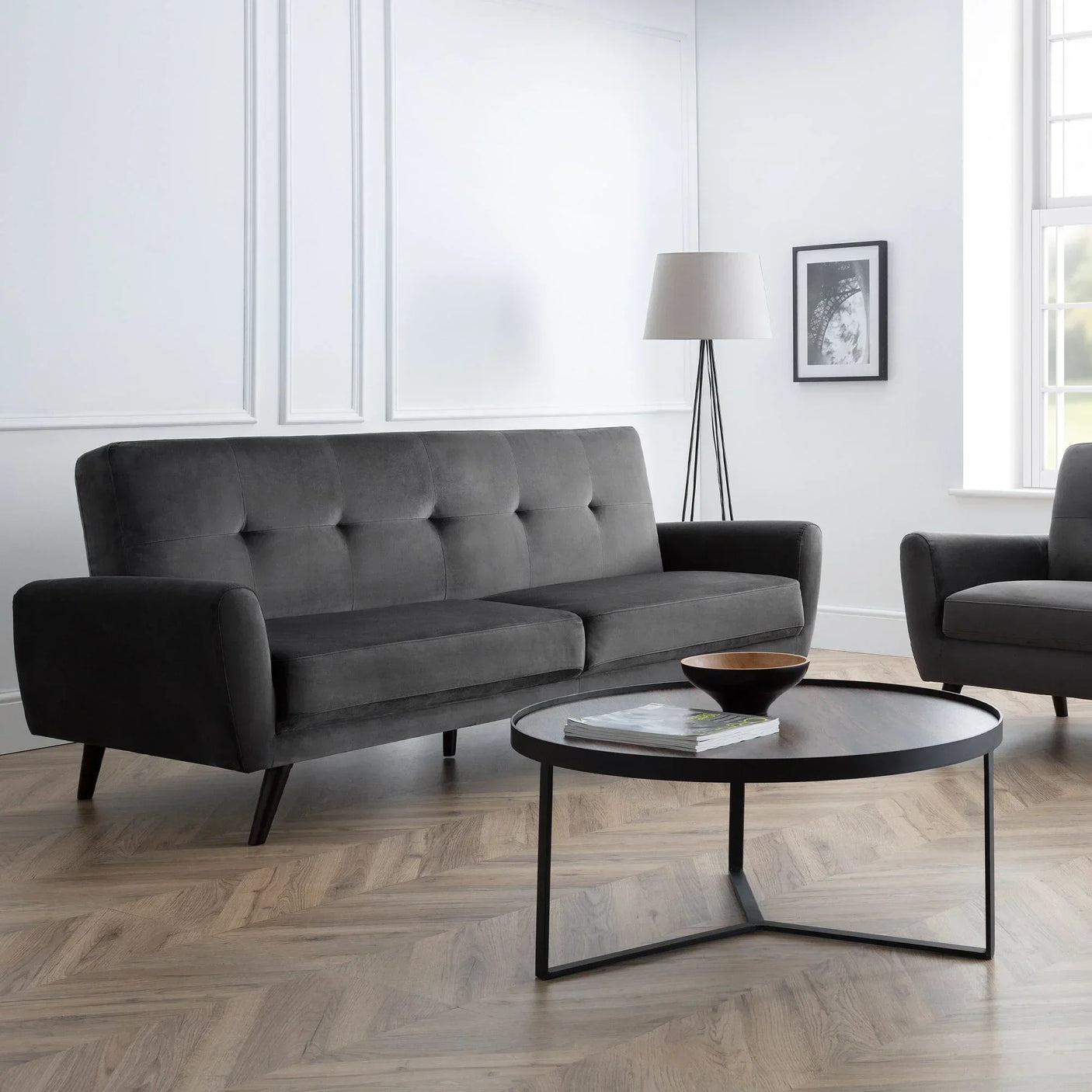 Grey velvet 2 seater sofa with button tufting in modern living room with round coffee table
