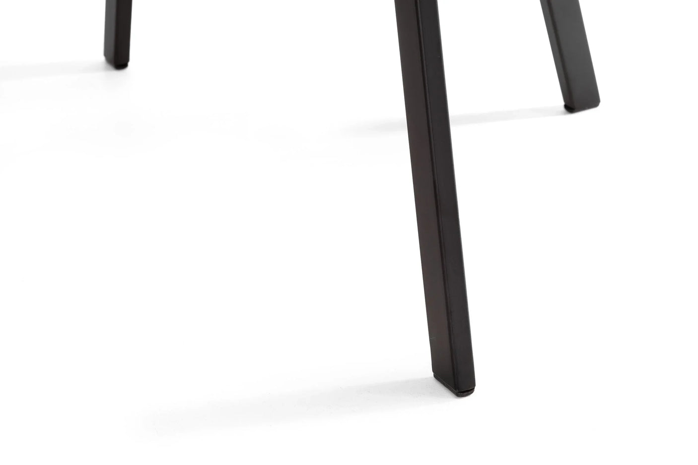 black metal dining chair legs close-up on white background