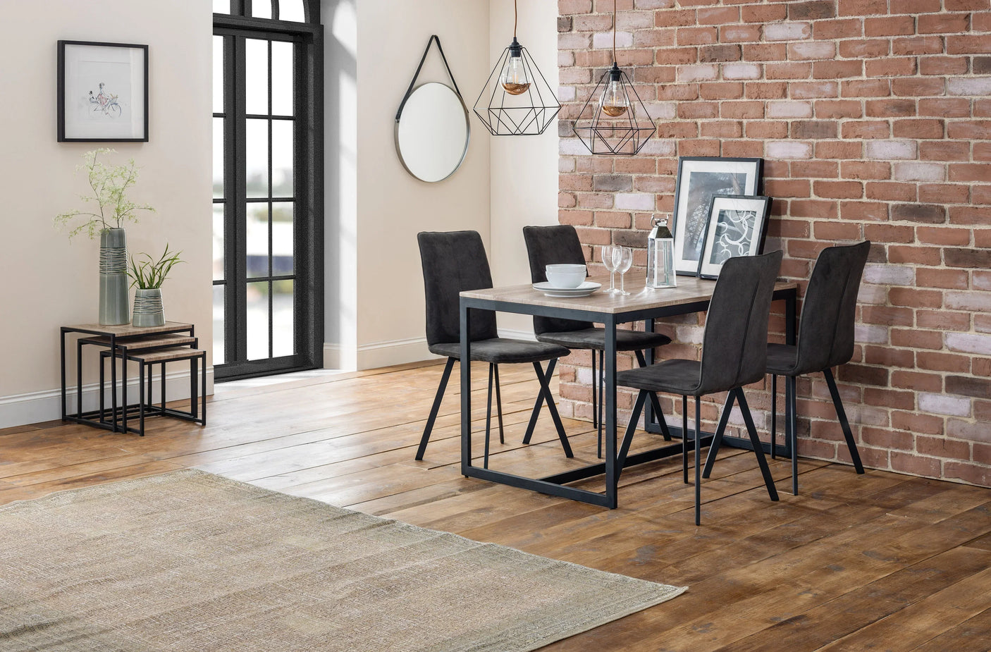 Grey fabric dining chairs with black legs around modern dining table in loft style room
