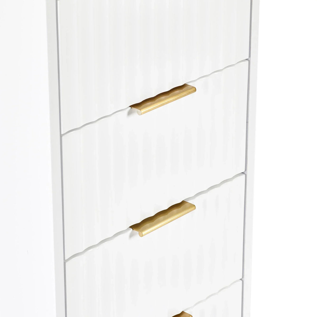 White chest of drawers with textured front and gold metal handles, side angle view