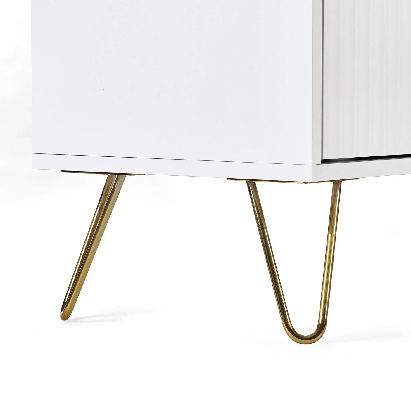 White cabinet with gold hairpin legs, close-up of modern furniture base