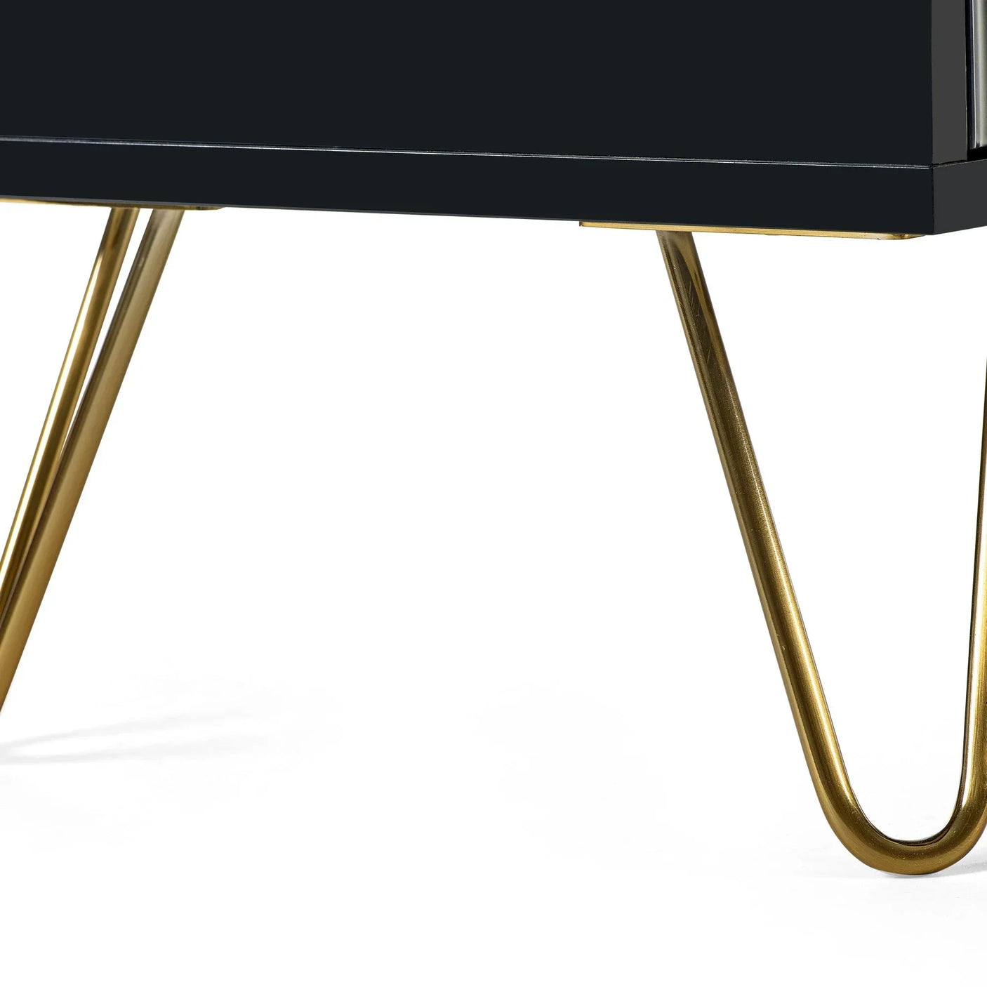 Black furniture unit with gold metal hairpin legs on white background