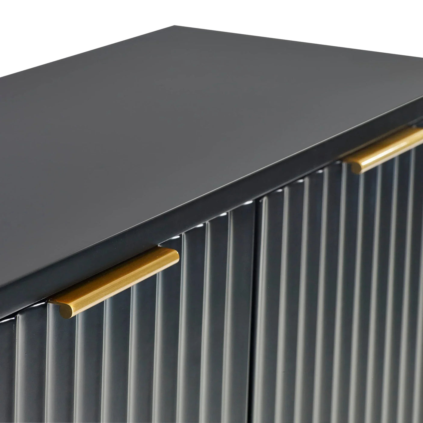 Black sideboard cabinet with ribbed doors and gold handles, close-up of top and handles