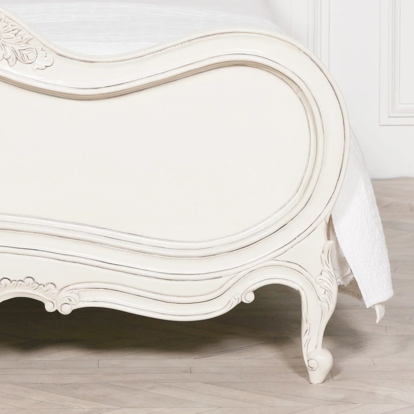 Cream French style bed footboard with carved detailing and curved wooden legs