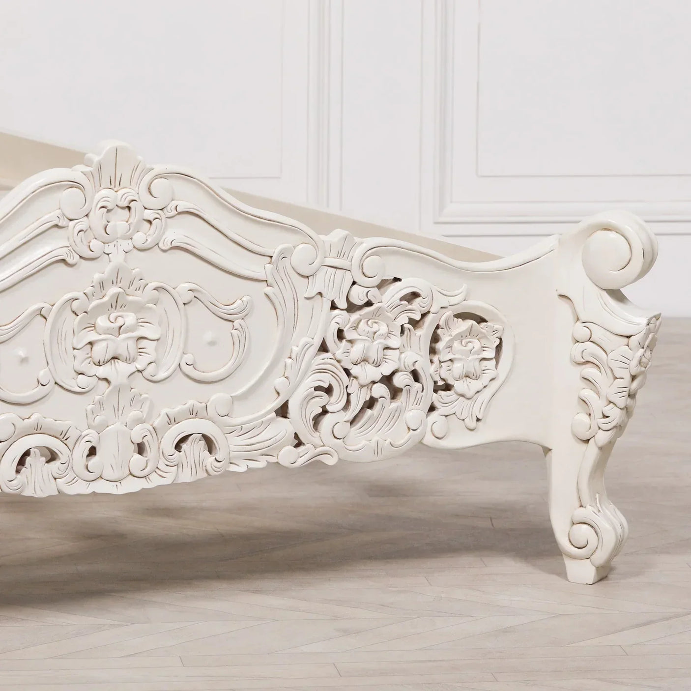 Cream carved wood bed footboard with floral detailing and ornate scrollwork