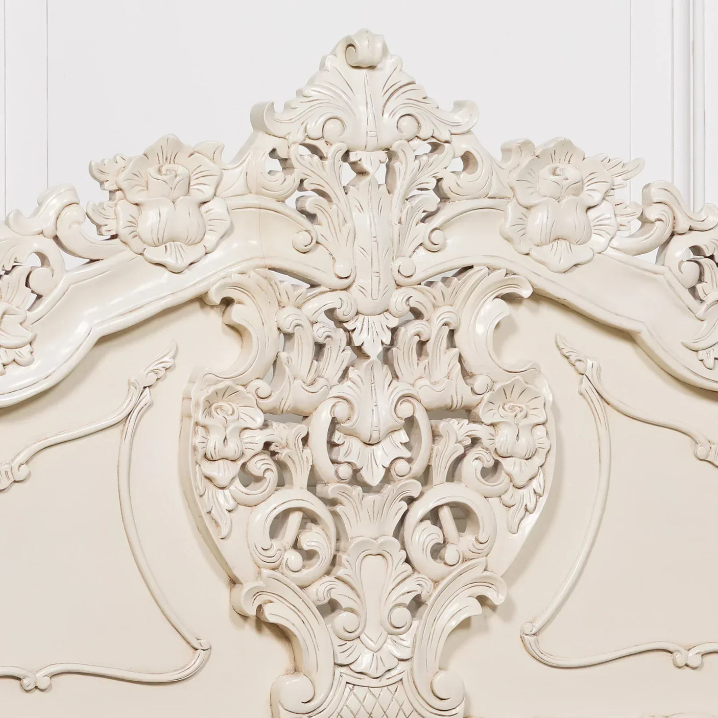 Cream ornate carved wood headboard with floral detail and baroque design
