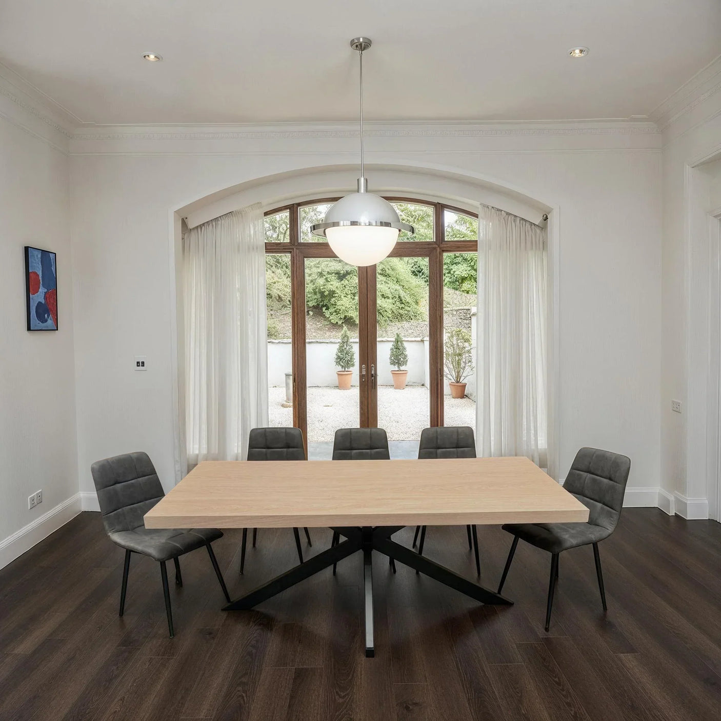 Rectangular oak dining table with six charcoal chairs in modern dining room