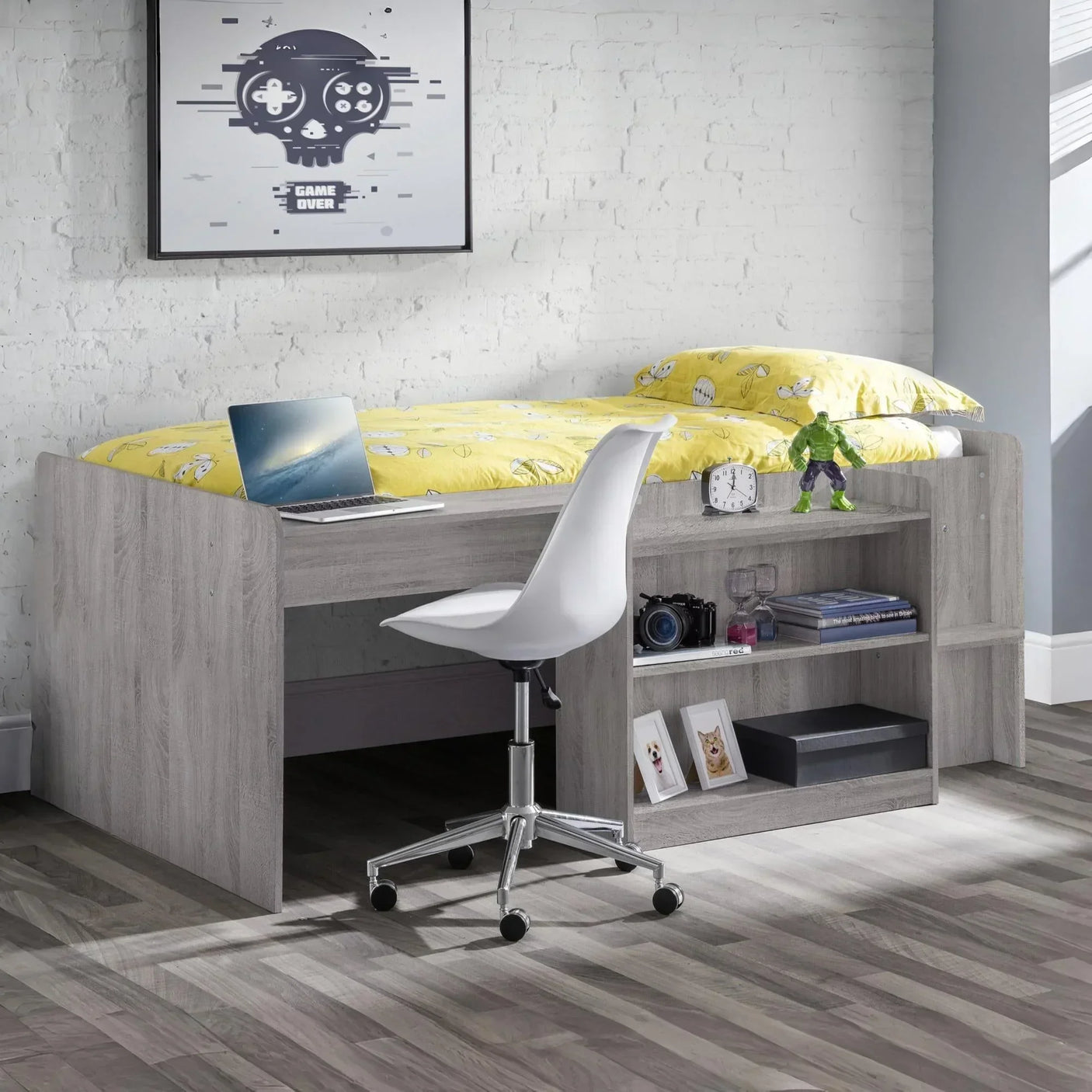Grey wooden mid sleeper cabin bed with built-in desk, shelves and yellow bedding in modern room