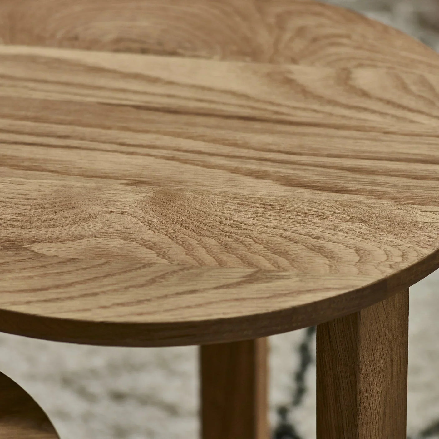Close up of natural wood grain on round nest of tables with smooth finish
