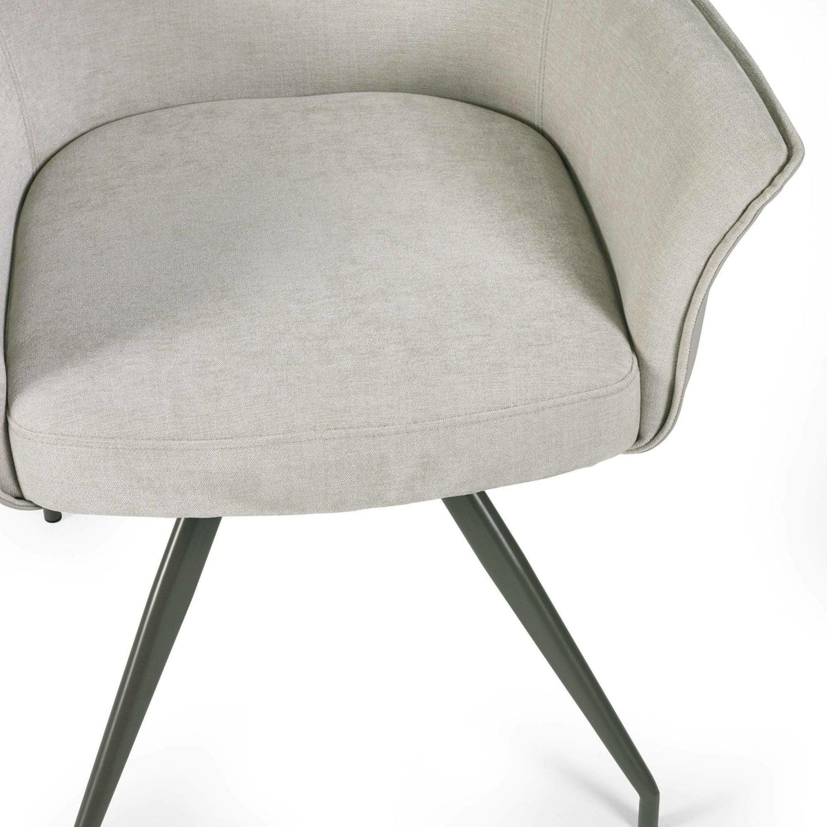 Light grey fabric dining chair with curved back and black angled metal legs, close view