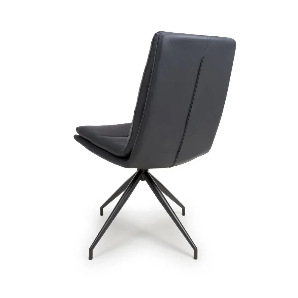 Black dining chair with cushioned seat and angled metal legs, rear view
