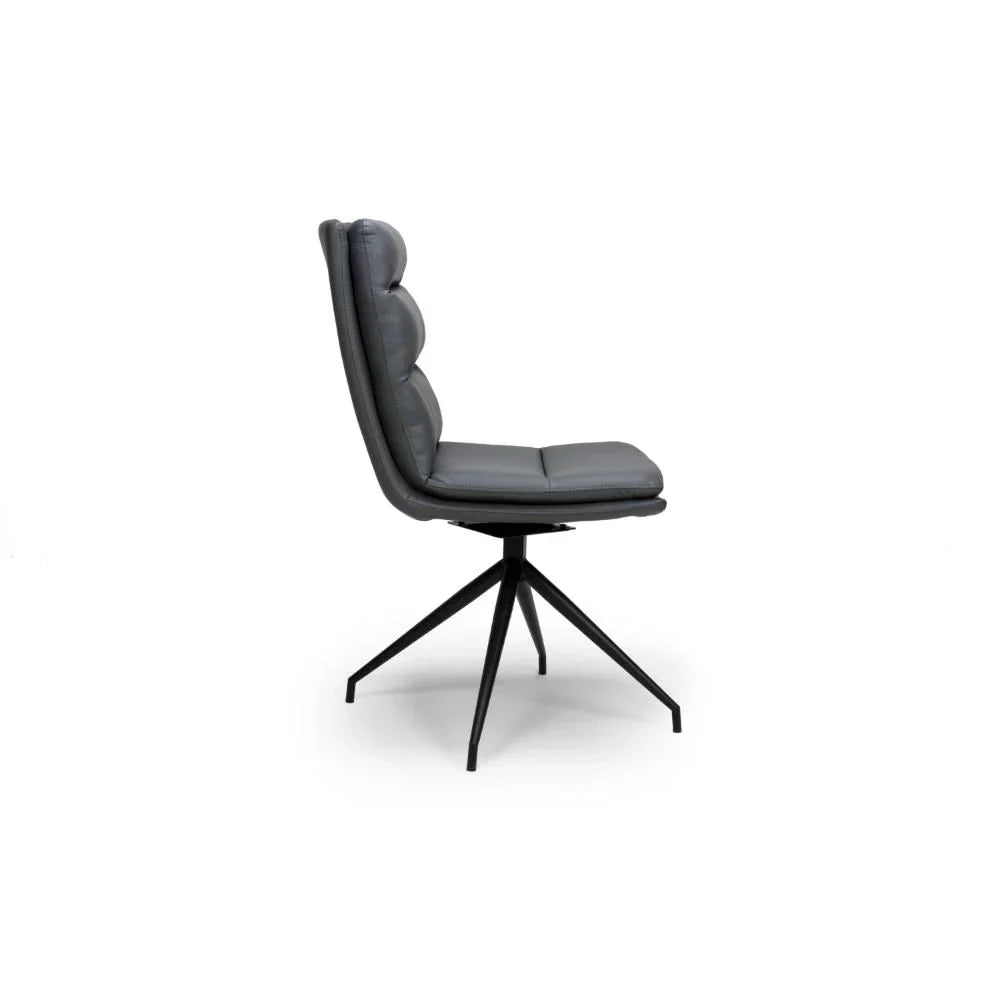 Grey leather dining chair with cushioned seat and black metal swivel legs, side view