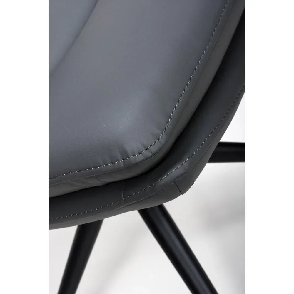 Closeup of grey faux leather dining chair seat with visible stitching and black legs