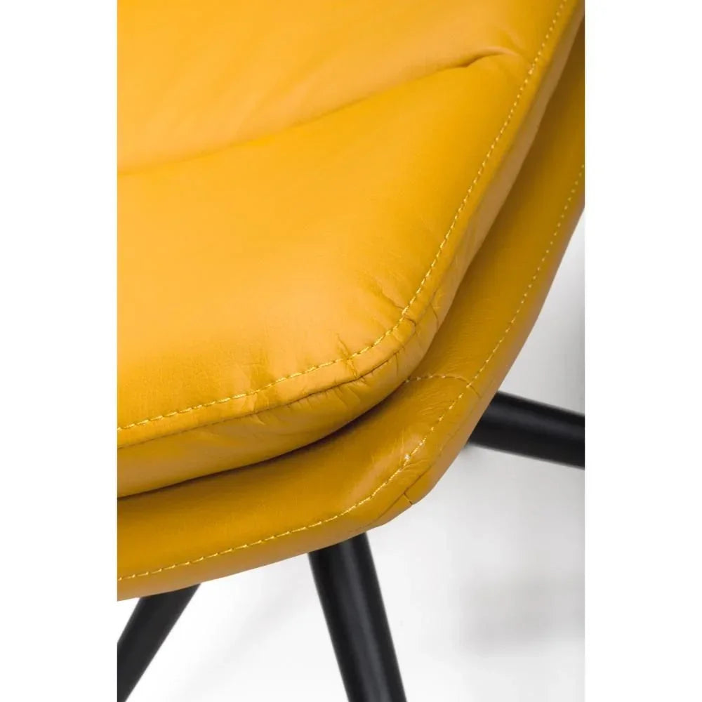 Closeup of yellow leather dining chair seat with black metal legs