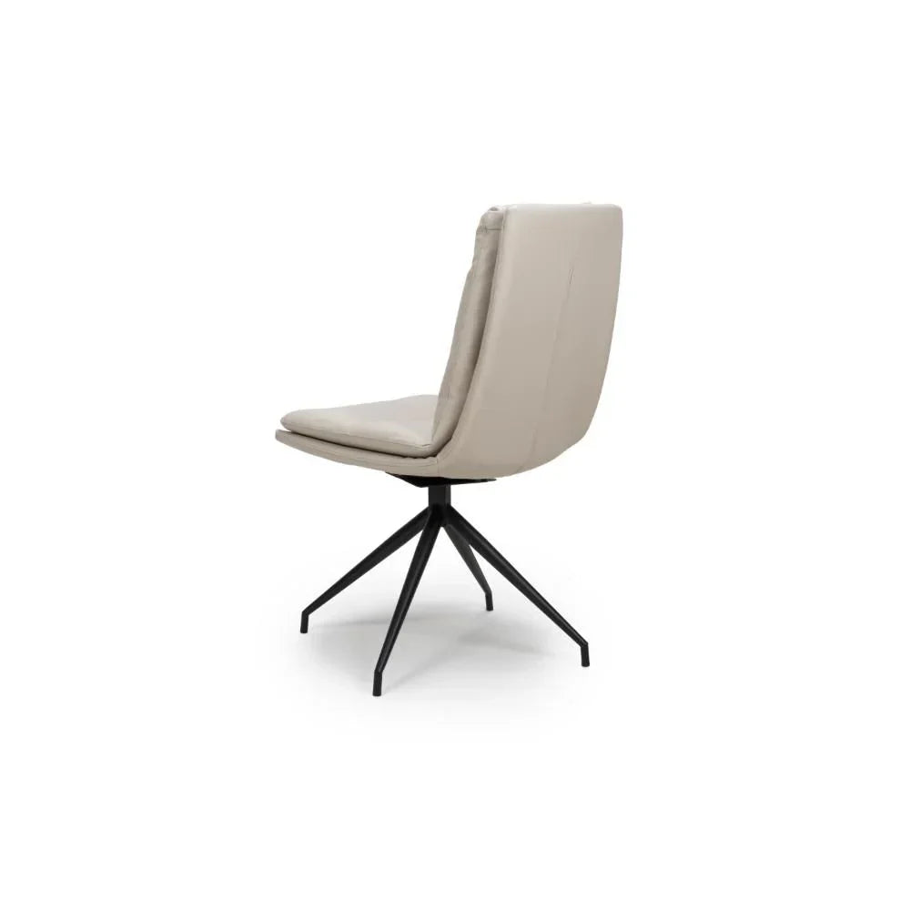 Beige dining chair with padded back and black metal legs, rear angle view