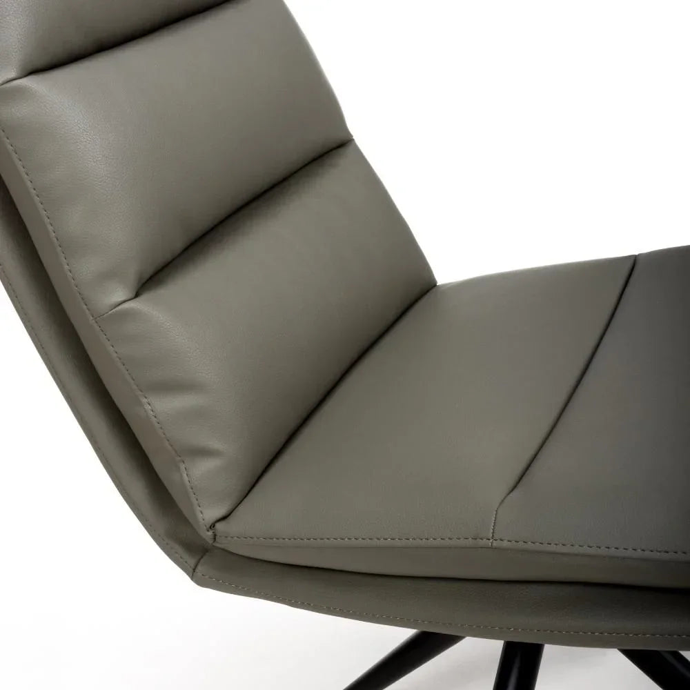 Closeup of grey leather dining chair seat and backrest with stitched detailing