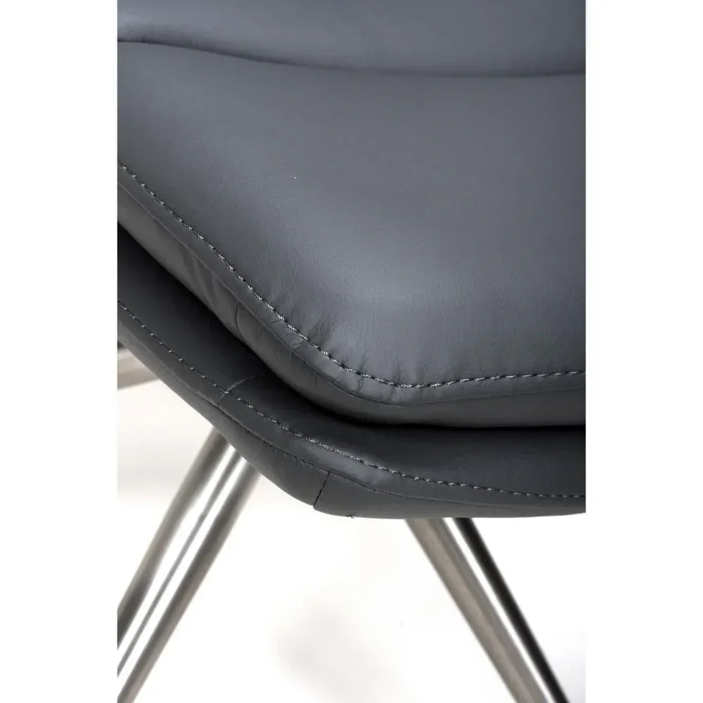 Close-up of grey dining chair cushion with visible stitching and chrome legs