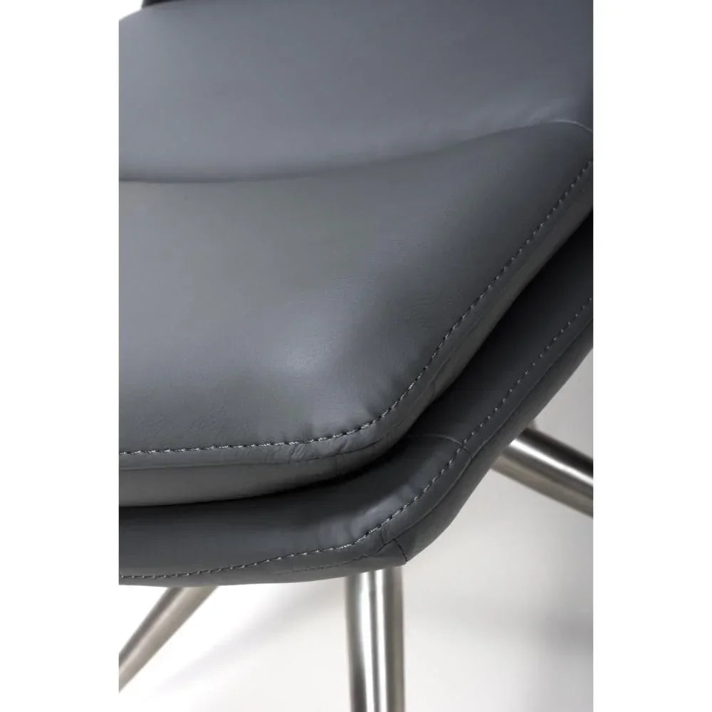 Close-up of grey leather dining chair seat with chrome legs