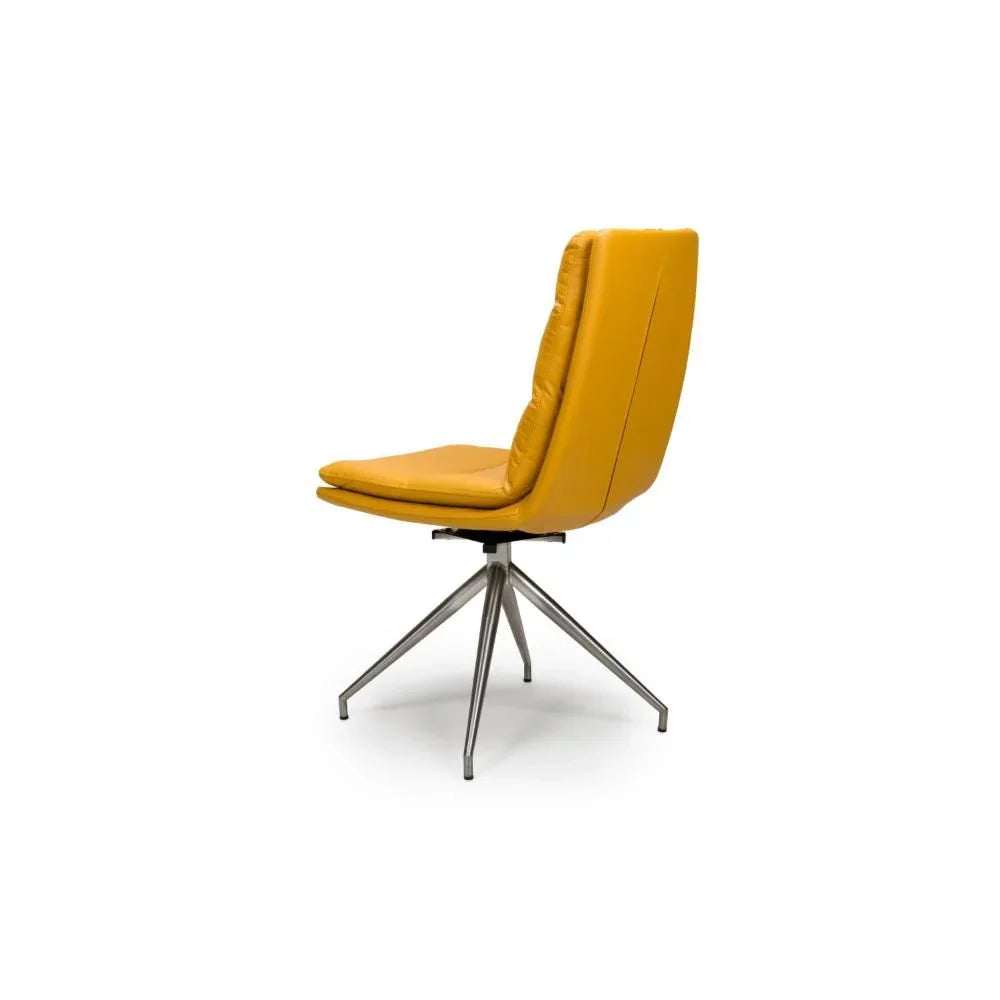 Mustard yellow dining chair with metal swivel base, side angle view on white background