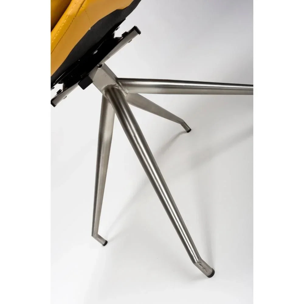 Dining chair brushed metal legs and corner of mustard seat against white background