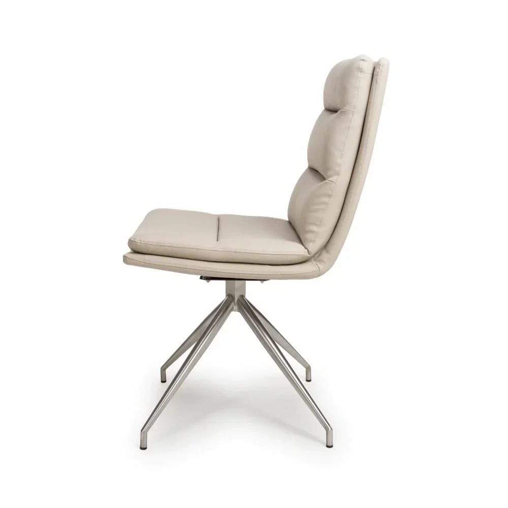 Beige dining chair with padded seat and back, brushed metal legs, side profile view