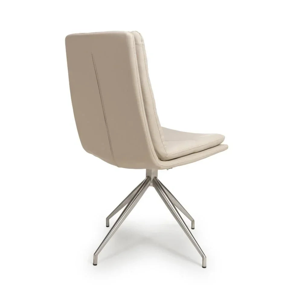 Beige faux leather dining chair with padded backrest and chrome swivel legs, rear view