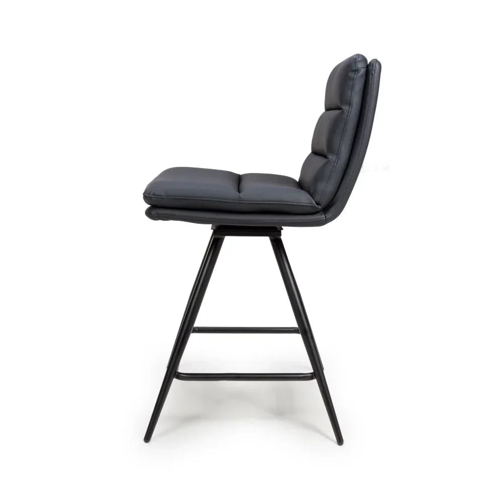 Black leather bar stool with padded seat and metal legs, side profile view