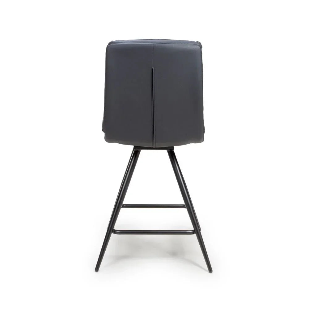 Black bar stool with padded backrest and metal legs viewed from behind