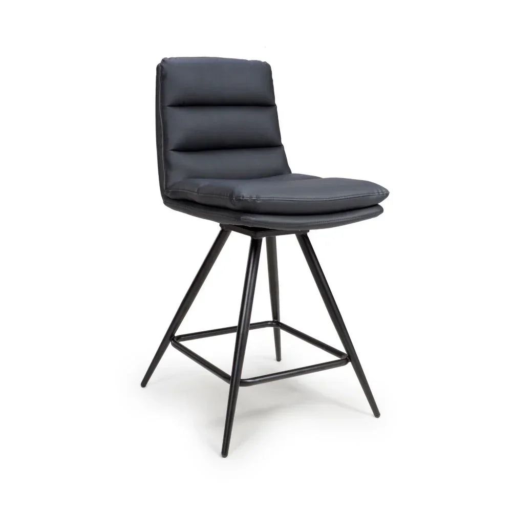 Black padded bar stool with metal legs and footrest, side angle view