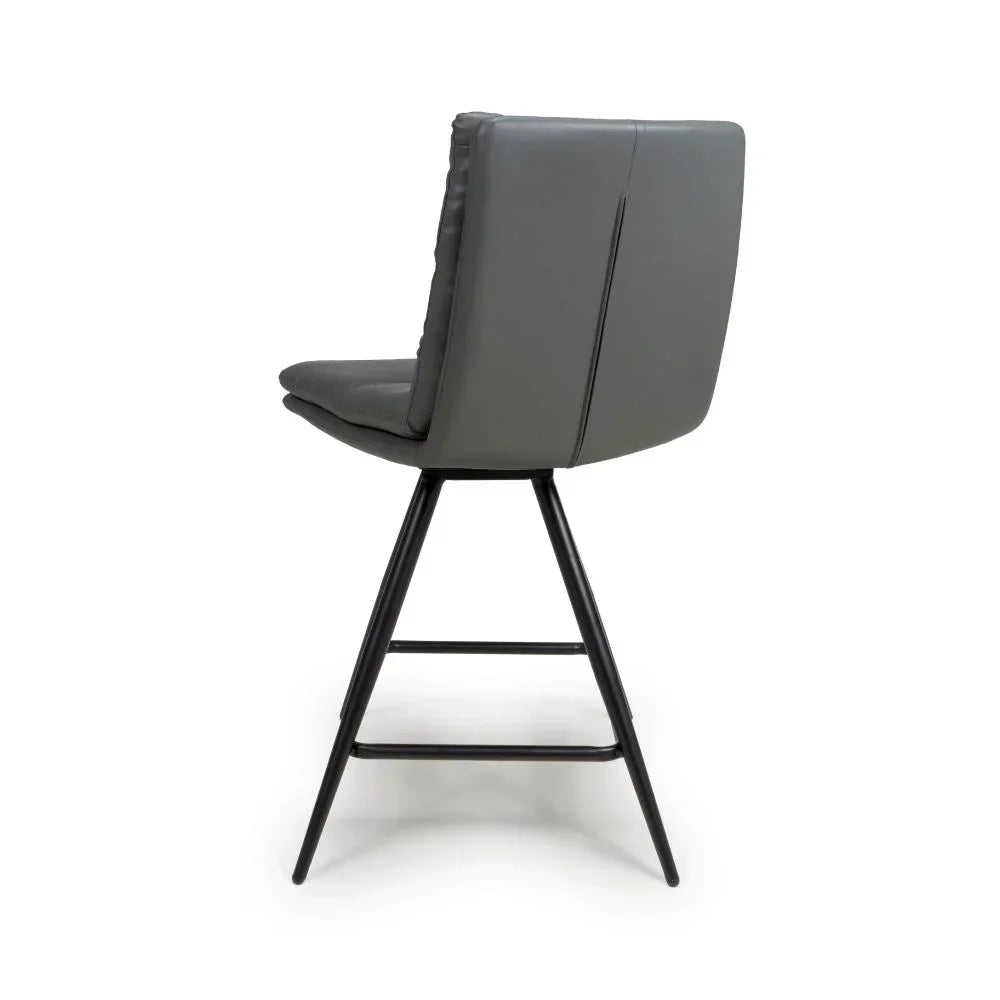 Grey faux leather bar stool with black metal legs, shown from rear angle