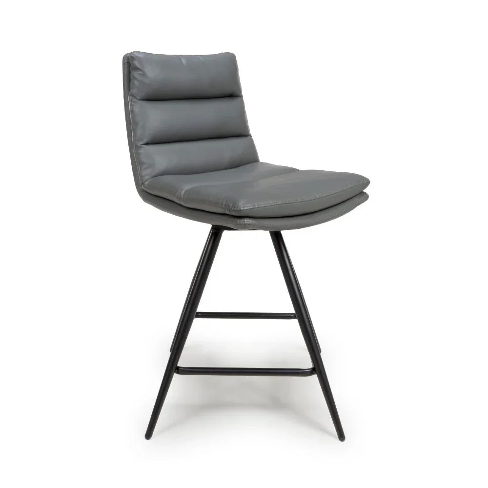 Grey faux leather bar stool with padded seat and metal legs, side view