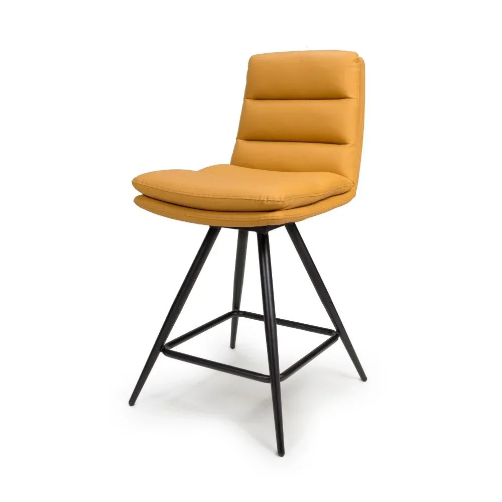 Mustard yellow bar stool with padded seat and black metal legs on white background