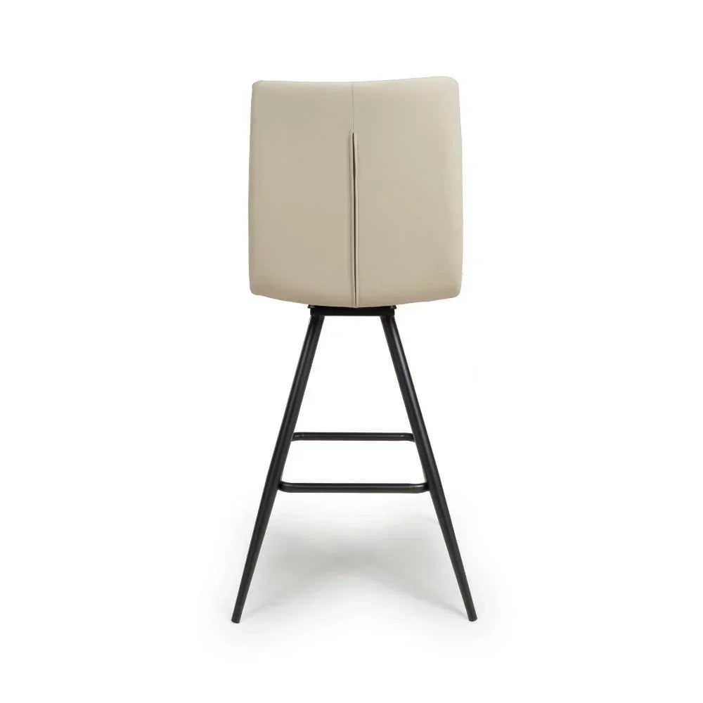 Back view of beige bar stool with black metal legs and high padded seat