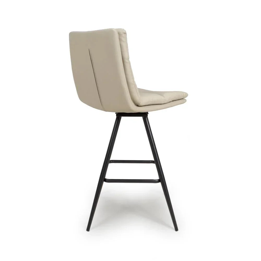 Beige upholstered bar stool with metal legs, side profile view