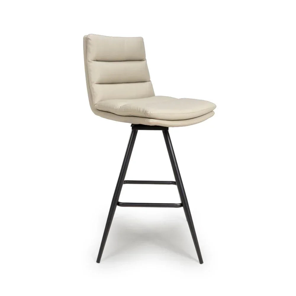 Beige upholstered bar stool with black metal legs and horizontal stitched backrest