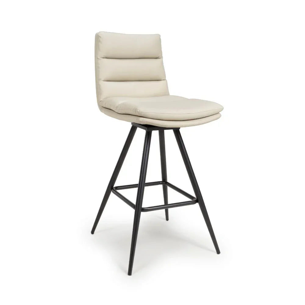 Beige upholstered bar stool with padded seat and black metal legs, side angle view