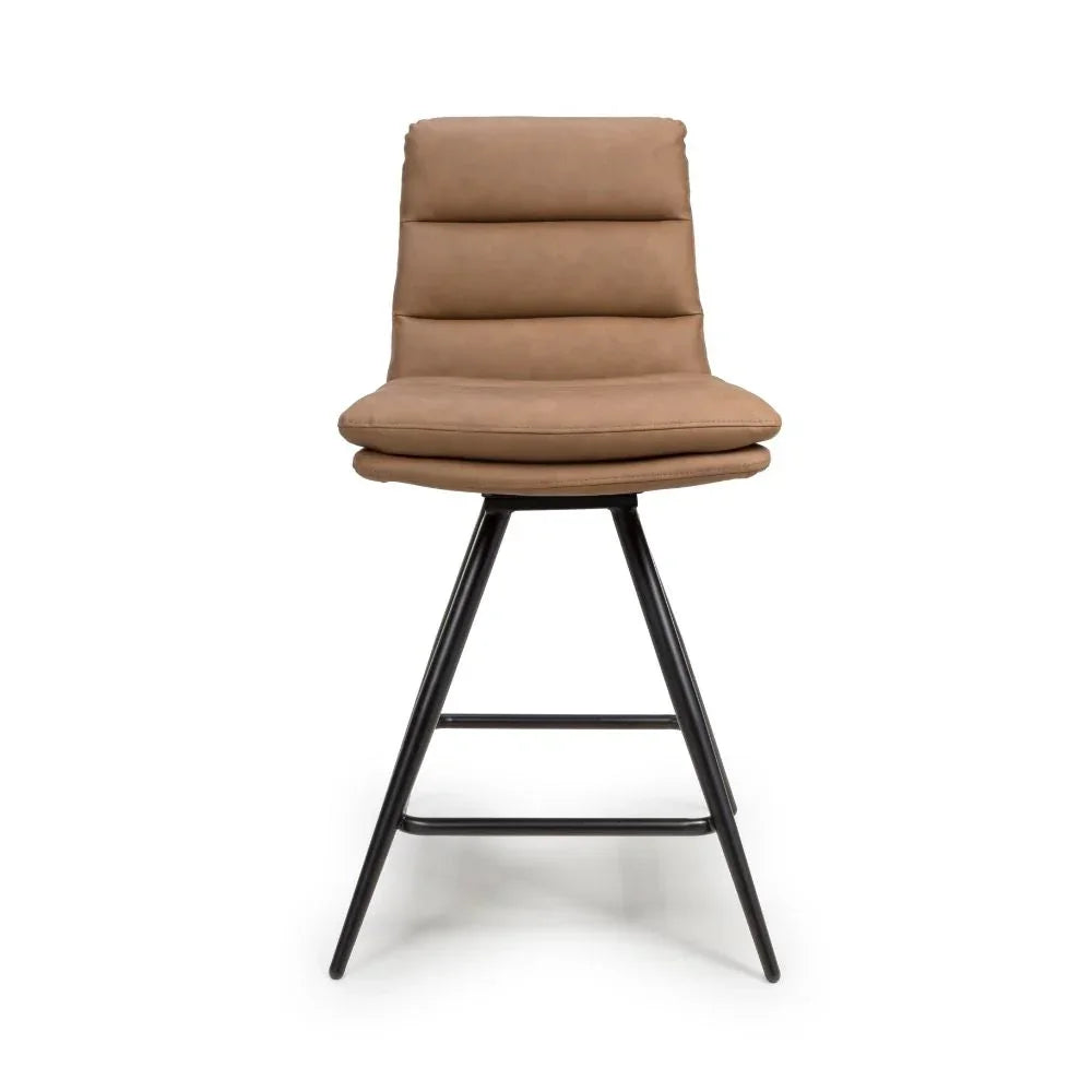 Tan bar stool with padded seat and black metal legs, front view