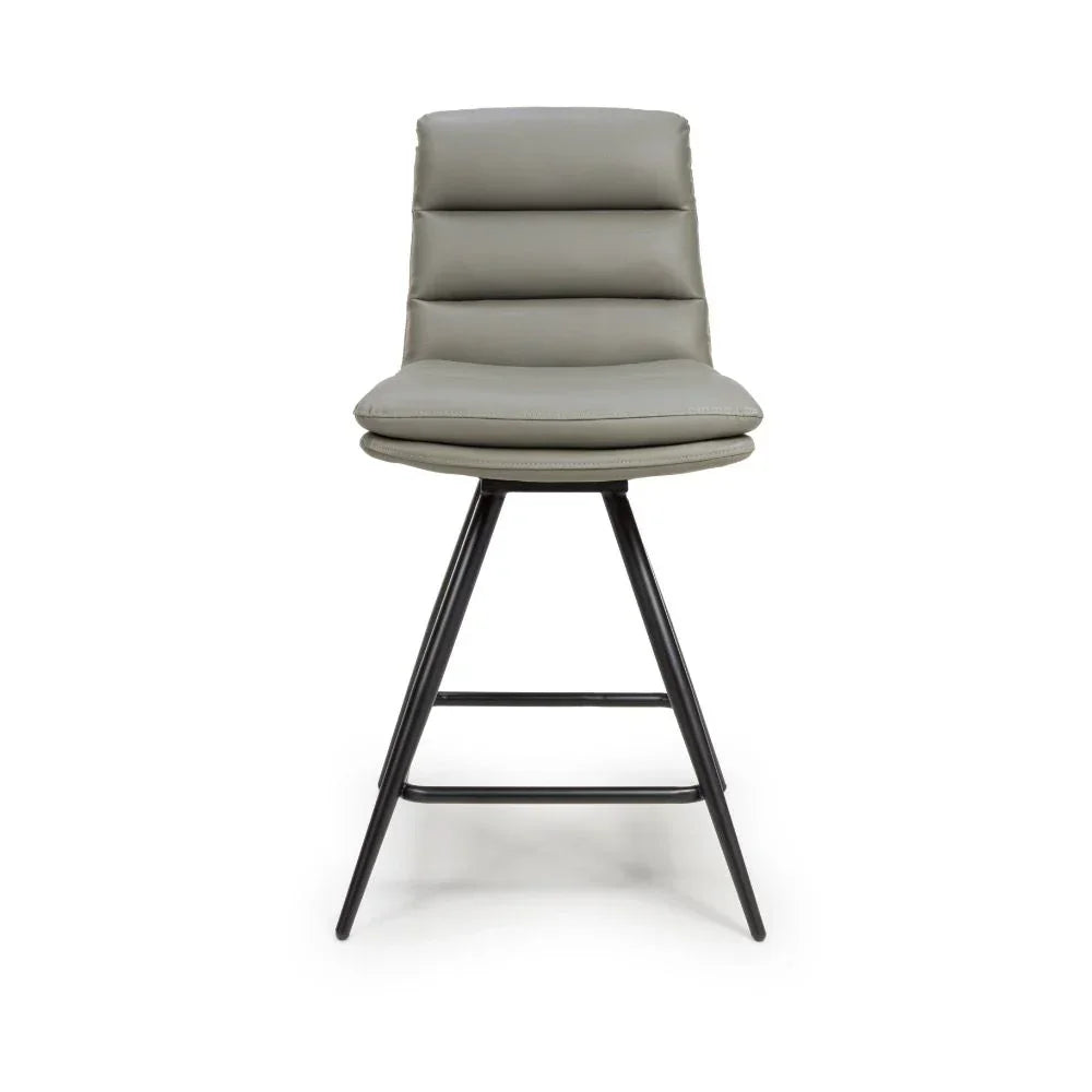 Grey cushioned bar stool with black metal legs and horizontal stitched backrest, front view