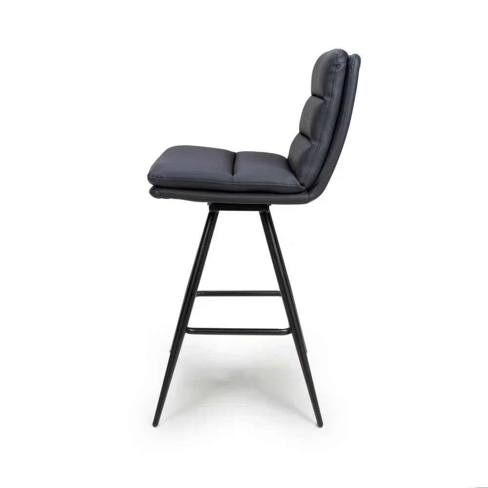 Black padded bar stool with metal legs and footrest, side view