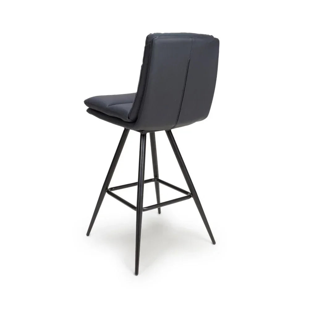 Black bar stool with padded seat, high backrest and metal legs, rear view