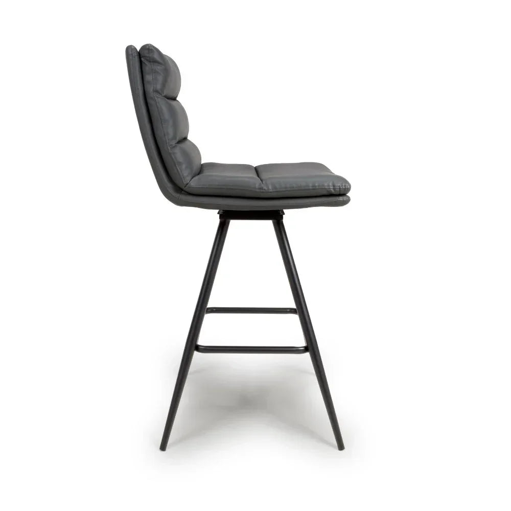 Grey leather bar stool with padded seat and black metal legs, side profile view